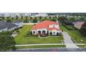Aerial view of a well-maintained house with a terracotta roof and lush green lawn at 5615 Oxford Moor Blvd, Windermere, FL 34786