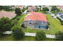 Aerial view of a home featuring a screened-in pool area with a terracotta roof at 5615 Oxford Moor Blvd, Windermere, FL 34786
