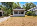 Charming single-story home features a covered porch and neutral exterior paint at 735 N Clara Ave, Deland, FL 32720