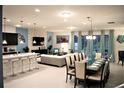 Bright, open-concept living space features a dining area, modern furniture, and stylish decorations at 8924 Bengal Ct, Kissimmee, FL 34747