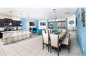 Bright, open-concept living space features a dining area, modern furniture, and stylish decorations at 8924 Bengal Ct, Kissimmee, FL 34747