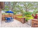 Outdoor patio area with brick accents featuring a table, chairs, and lush landscaping at 103 Golf Club Dr, Longwood, FL 32779