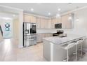 Modern kitchen features stainless steel appliances, granite countertops, and a cozy breakfast bar at 10915 Leafshore Loop, Orlando, FL 32829