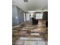 Comfortable living room featuring modern ceiling fan, new tile floors, and bright windows at 11 Pecan Run Ct, Ocala, FL 34472