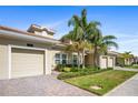 Charming home with lush landscaping, well-manicured lawn, and a two-car garage at 1161 Trappers Trail Loop, Davenport, FL 33896