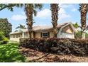 Charming home boasts mature palms, lush landscaping, and a tile roof, all enhancing its curb appeal at 11908 Delfina Ln, Orlando, FL 32827
