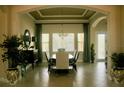 Bright dining room with a large window, a decorative chandelier, and stylish furnishings at 12030 Waterstone Loop Dr, Windermere, FL 34786