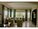 Comfortable living room featuring large windows, stylish curtains, and plush seating at 12030 Waterstone Loop Dr, Windermere, FL 34786
