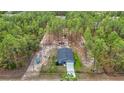 Beautiful aerial view of the home, landscaping, playground, and surrounding treed acreage on a private lot at 13297 Sw 69Th Pl, Ocala, FL 34481