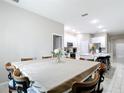 Large dining room featuring seating for eight, open to the kitchen and additional rooms at 13297 Sw 69Th Pl, Ocala, FL 34481