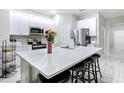 Open concept kitchen with center island, bar seating, and stainless steel appliances at 13297 Sw 69Th Pl, Ocala, FL 34481