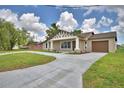 Charming single-story home featuring a decorative gable, covered front porch, and a long driveway at 1390 E Wabash St, Bartow, FL 33830