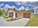 Charming single-story home featuring a decorative gable, covered front porch, and attached garage at 1390 E Wabash St, Bartow, FL 33830