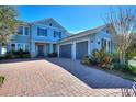 Inviting exterior showcasing a well-maintained home with a three-car garage and manicured landscaping at 14906 Speer Lake Dr, Winter Garden, FL 34787