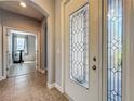 Home foyer featuring decorative glass front doors, archway to another room, and tile flooring at 17146 Cypress Preserve Pkwy, Orlando, FL 32820