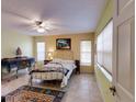 Cozy bedroom featuring tiled floor and neutral-colored walls at 17816 Se 115Th Ct, Summerfield, FL 34491