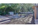 Inviting backyard with fire pit, mature trees, a hammock, and an entertainment deck at 1809 Pineview Cir, Winter Park, FL 32792