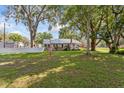 Spacious front yard featuring mature trees and a well-maintained lawn area at 2305 S Magnolia Ave, Sanford, FL 32771