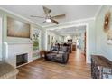 Open-concept living room with wood floors, fireplace, and view into the kitchen at 2305 S Magnolia Ave, Sanford, FL 32771