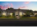 Charming stucco home with well-maintained landscaping and tile roof during dusk at 240 Promenade Cir, Lake Mary, FL 32746