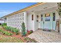 Inviting front porch with well-maintained landscaping and a beautiful light blue front door at 2510 Kiowa Trl, Fern Park, FL 32730