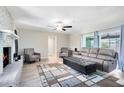 Spacious living room with brick fireplace, wood floors, and stylish furniture at 2618 Grassmere Ln, Orlando, FL 32808