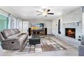 Cozy living room with a brick fireplace, modern furniture, and plenty of natural light at 2618 Grassmere Ln, Orlando, FL 32808