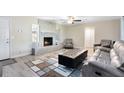 Bright living room features a beautiful fireplace, wood flooring, and neutral paint at 2618 Grassmere Ln, Orlando, FL 32808