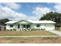 Charming single-story home boasts fresh paint, updated windows, and inviting front porch seating at 3212 Acoma Dr, Orlando, FL 32829