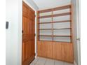 Foyer with wood-look bookcase and tile flooring, adjacent to the front door at 3212 Acoma Dr, Orlando, FL 32829