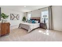 Bright main bedroom featuring soft carpet, crisp white walls, and a large window with light-filtering curtains at 3841 Royal Azalea Way, Sanford, FL 32773