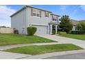 Gray stucco home with two car garage and manicured landscaping in front yard at 4054 Silverstream Ter, Sanford, FL 32771