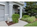 Covered entry of gray stucco home with nicely landscaped front yard at 4054 Silverstream Ter, Sanford, FL 32771