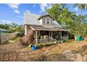 Charming two-story home with a metal roof and covered front porch at 419 Palm Ave, Eustis, FL 32726
