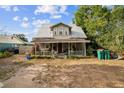 Charming two-story home with a metal roof and covered front porch at 419 Palm Ave, Eustis, FL 32726