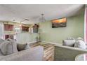 Inviting living room featuring wood-look floors, comfortable seating, and an open view to the kitchen at 4201 Chantelle Rd, Orlando, FL 32808