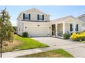 Charming two-story home with an attached two-car garage, well-kept lawn, and inviting curb appeal at 4459 Bluff Oak Loop, Kissimmee, FL 34746