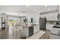 Modern kitchen with a center island, stainless steel appliances, and an adjacent dining area at 4459 Bluff Oak Loop, Kissimmee, FL 34746