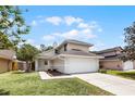 Charming two-story home with a well-manicured lawn and an attached two-car garage at 479 Cidermill Place, Lake Mary, FL 32746