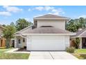 Exterior view of a cozy home with a two-car garage and a charming front yard at 479 Cidermill Place, Lake Mary, FL 32746