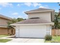 Two-story home featuring a two-car garage, walkway and partial lawn at 479 Cidermill Place, Lake Mary, FL 32746