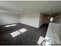 Spacious carpeted living room with natural light, perfect for relaxation and entertainment at 4891 Lyric Dr, Mascotte, FL 34753