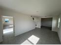 Bright living room featuring tile floors, neutral walls, and ample natural light from the windows at 4891 Lyric Dr, Mascotte, FL 34753