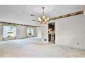Spacious living room with carpet floors and a chandelier at 715 Roughbeard Rd, Winter Park, FL 32792