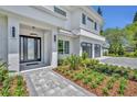 Inviting front entrance with modern door, stone walkway, and lush landscaping at 731 Williams Dr, Winter Park, FL 32789