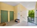 A building hallway with green doors, seating, and stairway at 8908 Legacy Ct # 303, Kissimmee, FL 34747