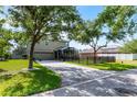 Back exterior of home with screened lanai, garage, and fenced yard at 913 Bending Oak Trl, Winter Garden, FL 34787