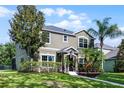 Beautiful home exterior featuring lush landscaping and a well-maintained lawn at 913 Bending Oak Trl, Winter Garden, FL 34787