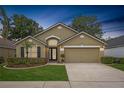 Charming single-story home with manicured lawn, two-car garage, and inviting front entrance at 9545 Southern Garden Cir, Altamonte Springs, FL 32714