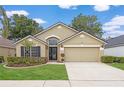 Charming single-story home with manicured lawn, two-car garage, and inviting front entrance at 9545 Southern Garden Cir, Altamonte Springs, FL 32714